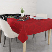 Red tablecloth with black-and-white design panel and centered crest