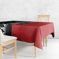Red tablecloth draped over table with black-and-white patterned side