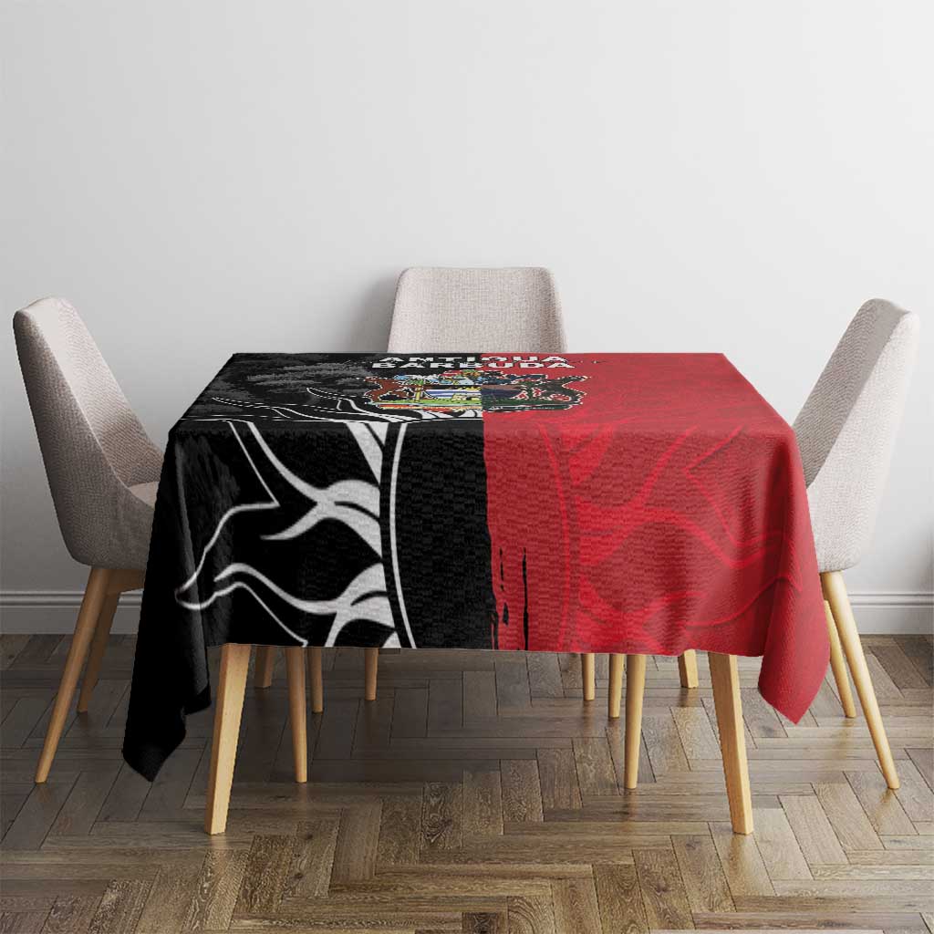 Red and black tablecloth with central Antigua and Barbuda crest on dining table