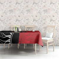 Red and black tablecloth with emblem and tropical graphics on dining table