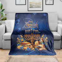 Blue Hanukkah blanket with menorah and 'Happy Hanukkah' lettering, spread across sofa.