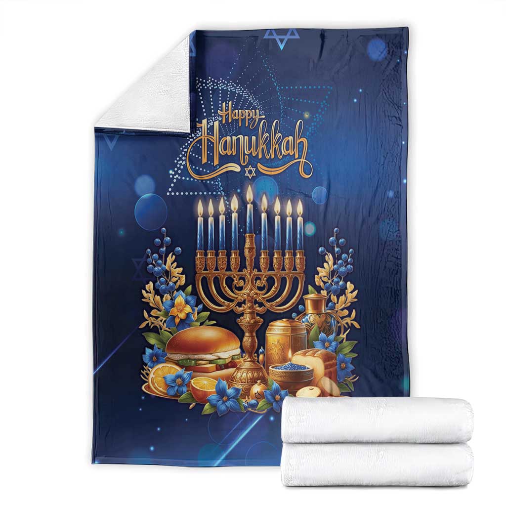 Blue Hanukkah blanket with menorah and 'Happy Hanukkah' design, folded with white throws.