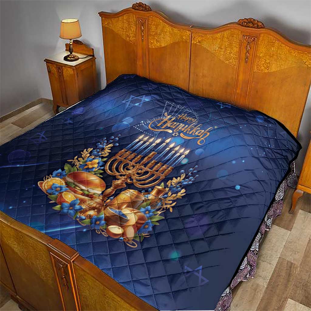 Blue Hanukkah quilt on bed with menorah candles, gold decorations, and quilt stitching