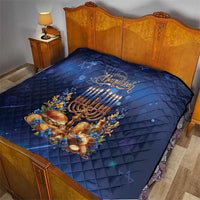 Blue Hanukkah quilt on bed with menorah candles, gold decorations, and quilt stitching