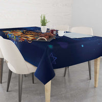 Blue Hanukkah tablecloth draped on dining table with menorah and decorative plants