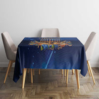 Blue Hanukkah tablecloth on dining table featuring menorah and gold accent details