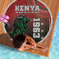 Round red Kenya beach blanket with green lion and patterned flag design, white fringe