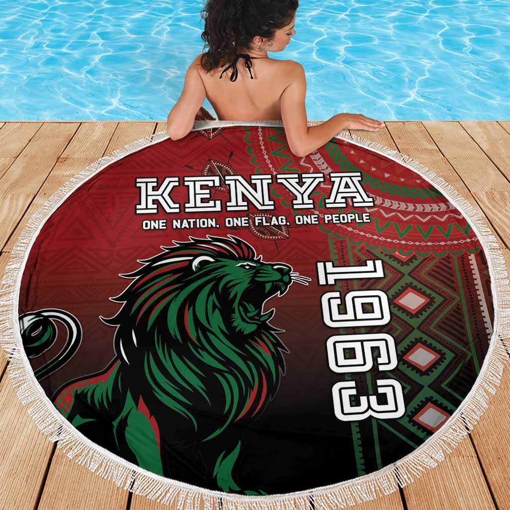 Round Kenya beach blanket with red lion artwork and white fringe, laid on wooden deck