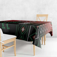 Black tablecloth with red top edge and green patterned blocks, draped over chair and table