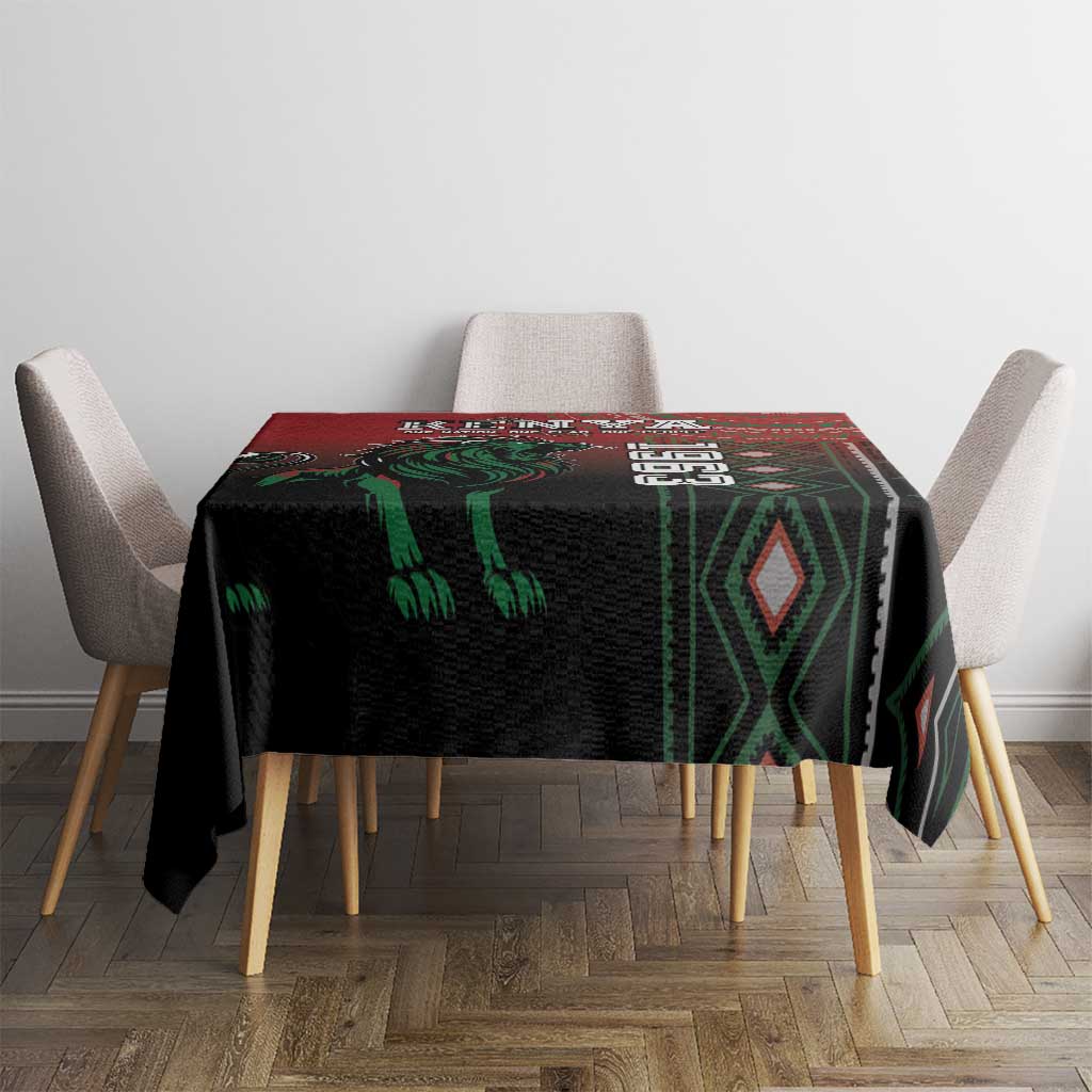 Square tablecloth in black with green accents and red header band, styled on dining table