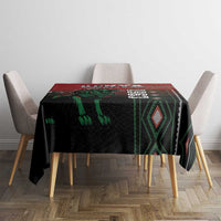 Square tablecloth in black with green accents and red header band, styled on dining table