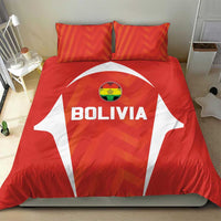 Red Bolivia bedding set showing 'BOLIVIA' shield on duvet with two orange geometric pillows