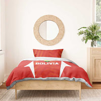 Red Bolivia duvet set with 'BOLIVIA' crest on front and two orange-pattern pillows