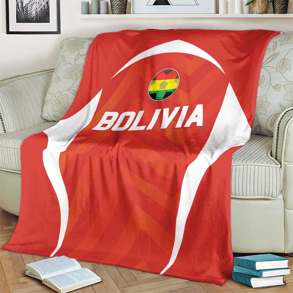 Red Bolivia football blanket with large BOLIVIA lettering and white emblem shape on couch
