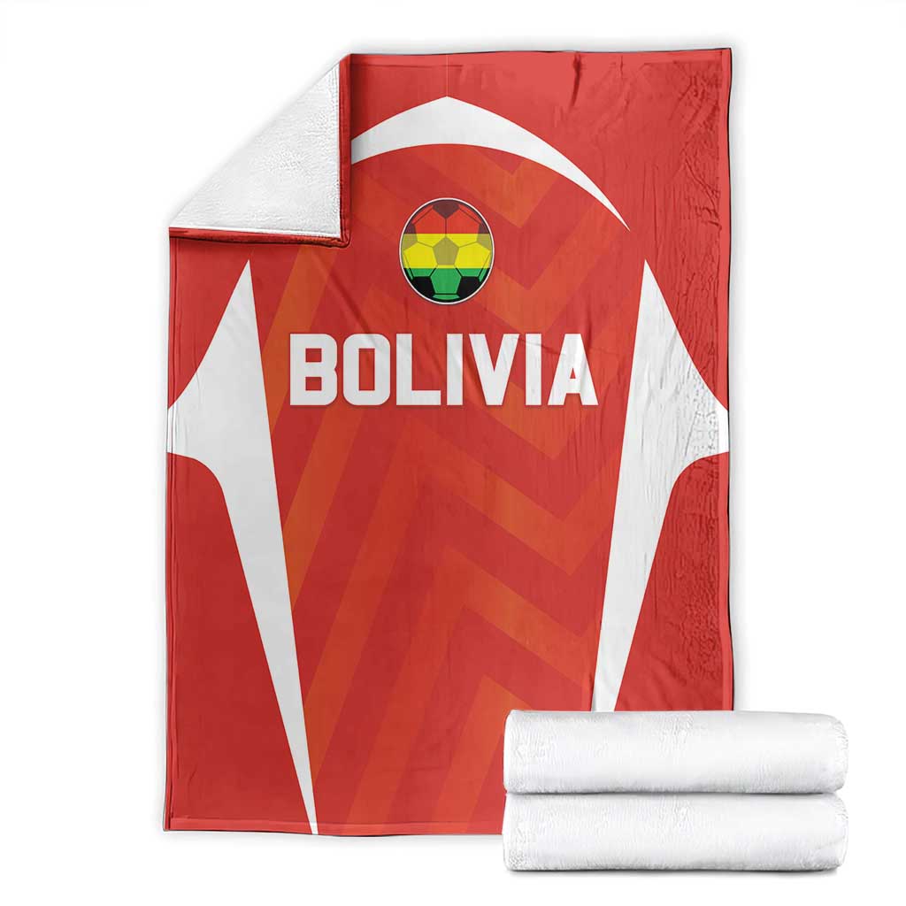 Red Bolivia football blanket with white stripes, crest and BOLIVIA text, folded with towels