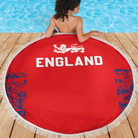 Red England round beach blanket with white fringe, lion crest and “ENGLAND” across the center.