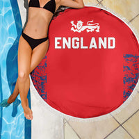 Red England round beach blanket with white fringe, “ENGLAND” text and lion crest on the front.