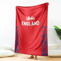Red England cricket blanket draped, with Three Lions emblem and blue side pattern