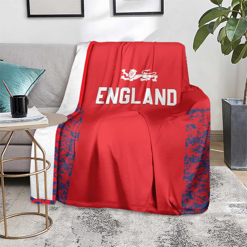 Red England cricket blanket on floor with ENGLAND lettering and blue side panels