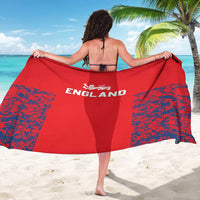 Red England sarong with white 'ENGLAND' logo and blue speckled side panels, worn as wrap.