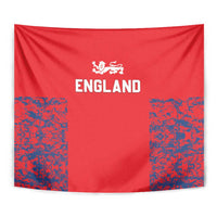 Red England tapestry close-up with white lion crest, “ENGLAND” lettering, and blue speckled corners.