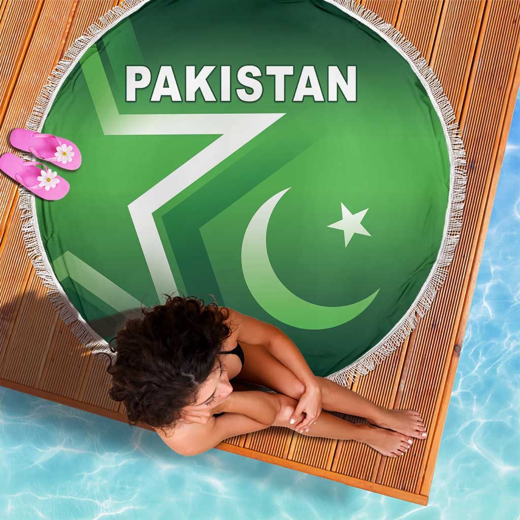 Green round beach blanket with Pakistan flag graphic and fringed border; close view