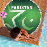 Green round beach blanket with Pakistan flag graphic and fringed border; close view