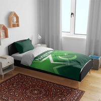 Green Pakistan duvet on bed with two pillows, wide crescent and star across the center