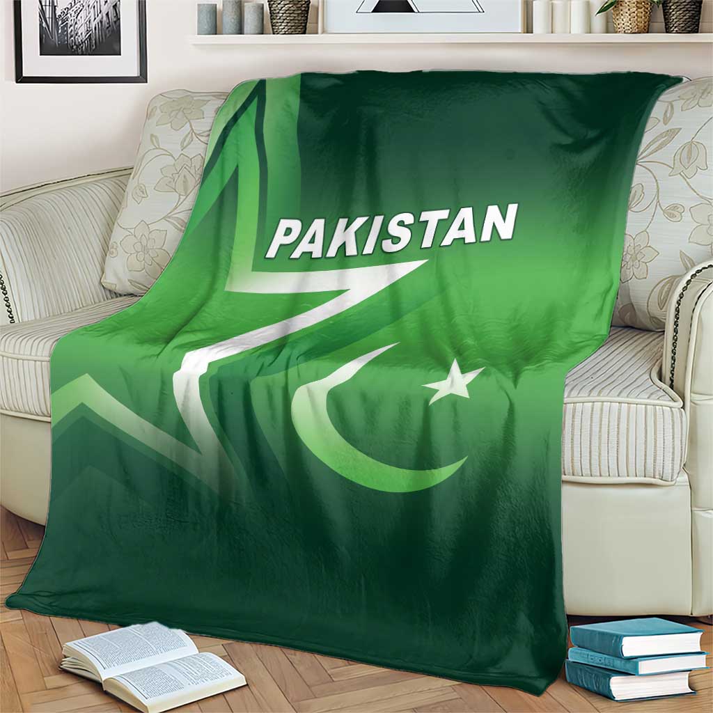 Green Pakistan cricket blanket on a cream sofa, featuring Pakistan text and crescent star