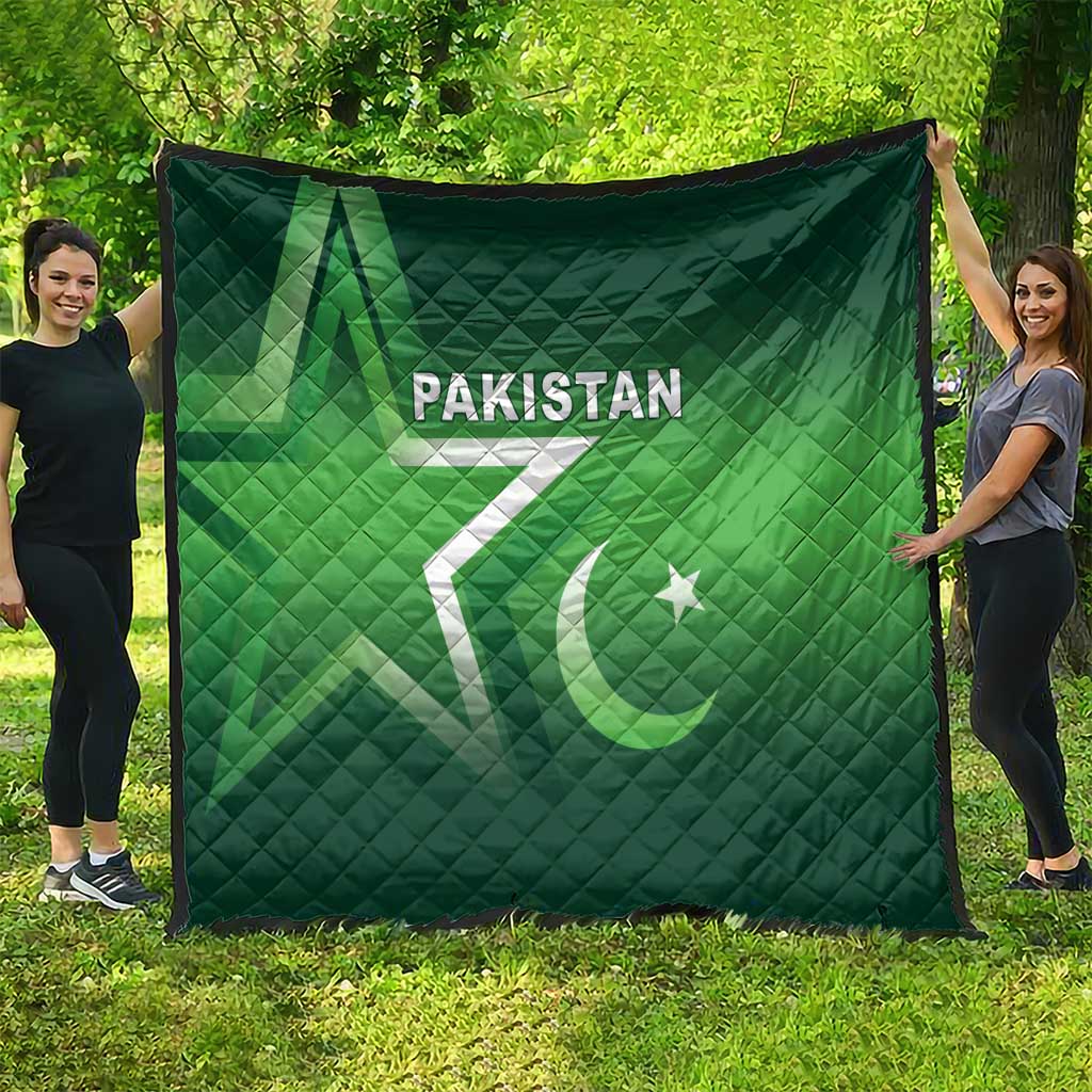 Green Pakistan quilt draped outdoors, diamond quilting with “PAKISTAN” text and crescent star