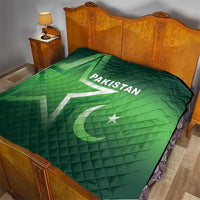 Green Pakistan quilt on a bed, diamond quilting with “PAKISTAN” text and crescent star