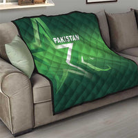 Green Pakistan quilt on a living room sofa, diamond quilting with “PAKISTAN” text