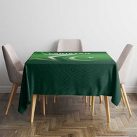 Green Pakistan-themed tablecloth with flag symbols, draped over a square table.