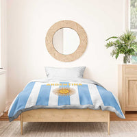 Bedding set on bed with blue-and-white stripes, sun emblem and centered ARGENTINA text