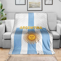 Soft Argentina football blanket on gray sofa, blue vertical stripe and sun crest