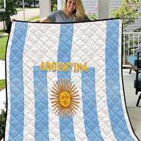 Argentina-themed quilt with white and light-blue vertical stripes, sun emblem and logo.