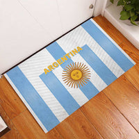 Argentina football rubber doormat on wood floor, blue-and-white stripes with ARGENTINA sun logo