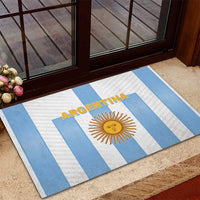 Argentina football rubber doormat on outdoor step, blue-and-white stripes with sun logo