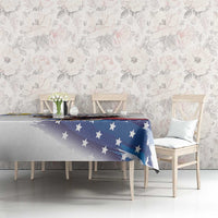 White tablecloth with blue stars and eagle-themed print over dining table