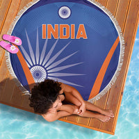 Round blue beach blanket with INDIA text, orange diagonal stripe, and white fringe