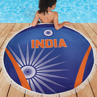 Blue round beach blanket with INDIA lettering, orange stripes, and white tassel fringe