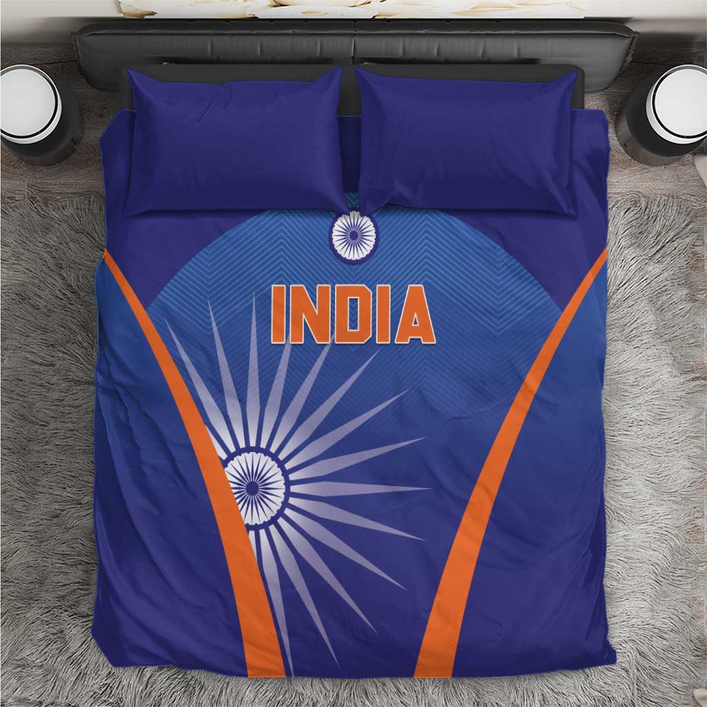 Blue India-themed duvet cover with orange diagonal stripes and sunburst design, plus pillows