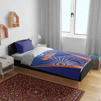 Blue India-themed bedding set on a bed with duvet, matching pillowcases, orange stripe accents