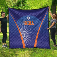 Blue India quilt draped outdoors with orange V border, 'INDIA' text and wheel graphic