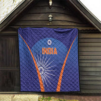 Blue India quilt hung on wall, orange V stripes, 'INDIA' logo and wheel accents