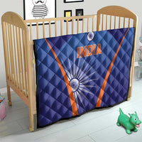Blue quilt on baby bed with orange V trim, 'INDIA' text and wheel accents