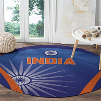 Blue round carpet with INDIA text and orange trim over white sunburst chakra design