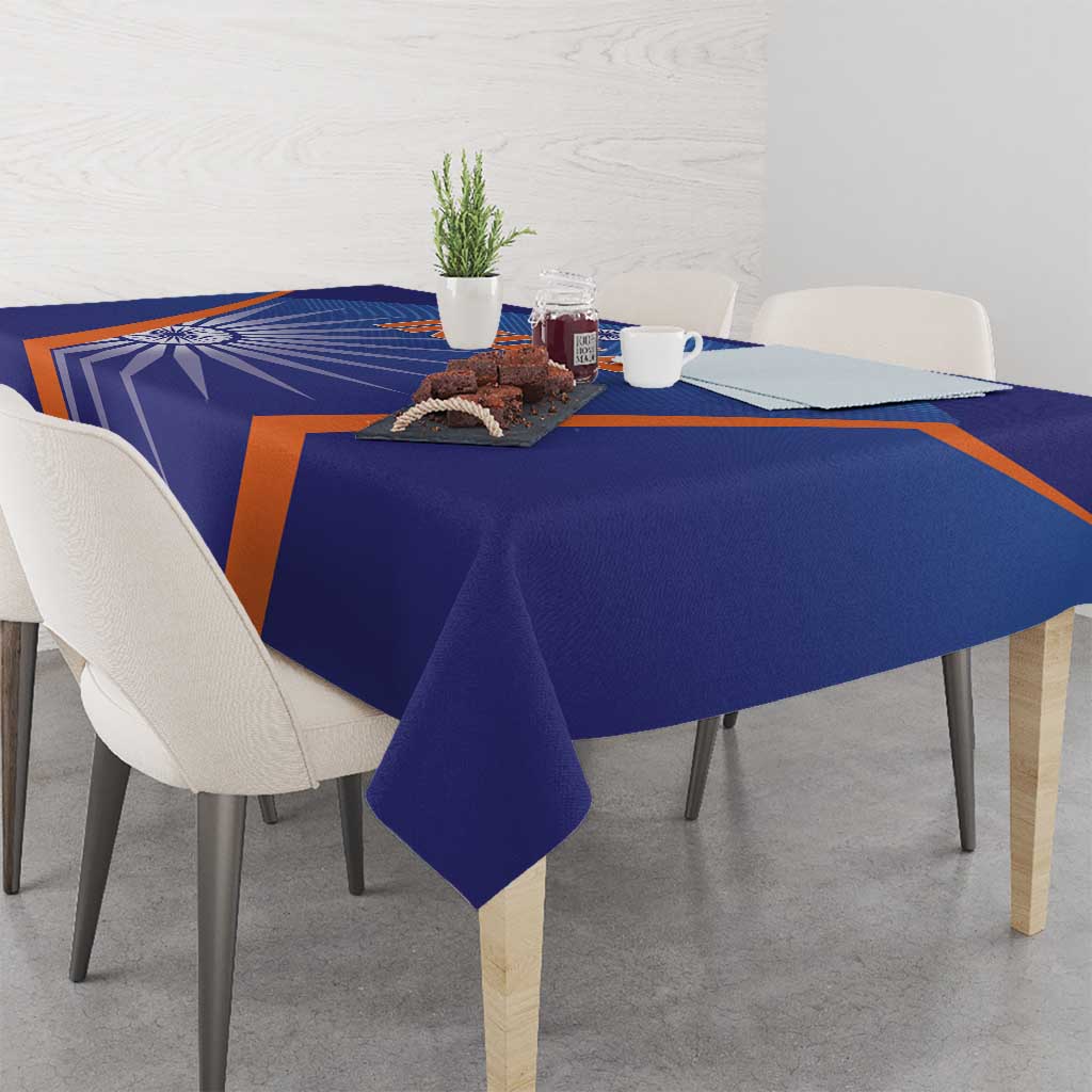 Blue India cricket tablecloth with orange stripe pattern, corners and fold visible.