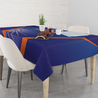 Blue India cricket tablecloth with orange stripe pattern, corners and fold visible.