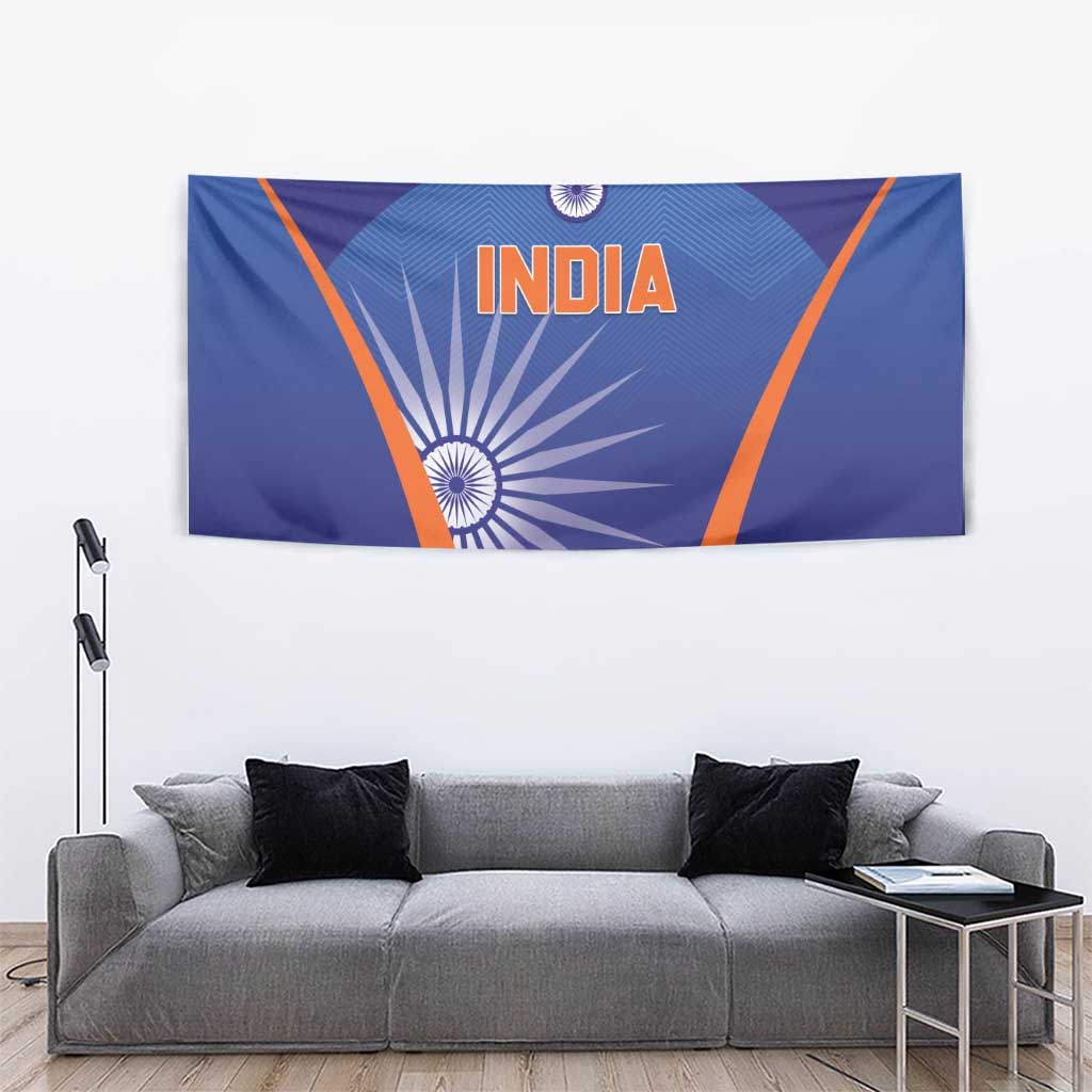 Blue India cricket tapestry on wall behind gray couch, orange border and INDIA text
